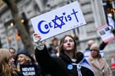 A protester holds reading "Coexist" during a demonstration in central London on Sunday to protest against antisemitism. Photo by JUSTIN TALLIS / AFP