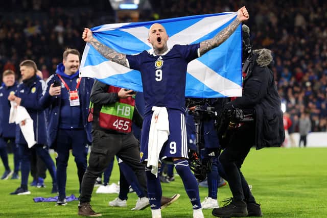 Scotland striker Lyndon Dykes celebrates the victory over Denmark which ensured qualification for this year's World Cup (Picture: Ian MacNicol/Getty Images)