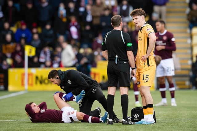 Hearts midfielder Cammy Devlin receives treatment during the 0-0 draw with Livingston.