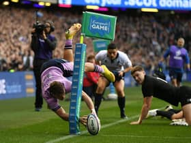An airborne Darcy Graham scores what looks like a spectacular try against New Zealand only for it to be overturned for a foot in touch. (Photo by Ross MacDonald / SNS Group)