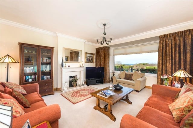 Sitting room with picture window overlooking the garden, and gas fire.