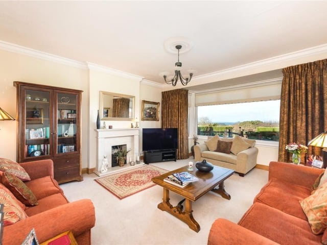 Sitting room with picture window overlooking the garden, and gas fire.