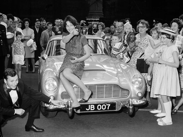 Anna Tweedie perches on James Bond's Aston Martin, which arrived in Edinburgh for a premiere of Thunderball in August 1965.