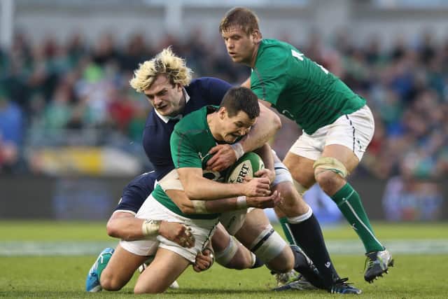 Johnny Sexton of Ireland is tackled by Richie Gray during the 2014 Six Nations match between Ireland and Scotland. Gray is back in contention after a four-year absence while Sexton is confident of playing despite an injury worry. Picture: David Rogers/Getty Images
