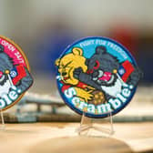 Badges depicting a Formosan black bear holding a Taiwanese flag punching Winnie-the-Pooh are on display at a shop in Taoyuan, Taiwan. China, which claims Taiwan as part of its territory, launched three days of war games on 8 April that involved simulating attacks on the democratic island in response to President Tsai Ing-wen's meeting with US House Speaker Kevin McCarthy. The iron-on patches being worn by some of Taiwan's air force pilots are a defiant message to Chinese leader Xi Jinping, often satirised for looking like Winnie the Pooh.