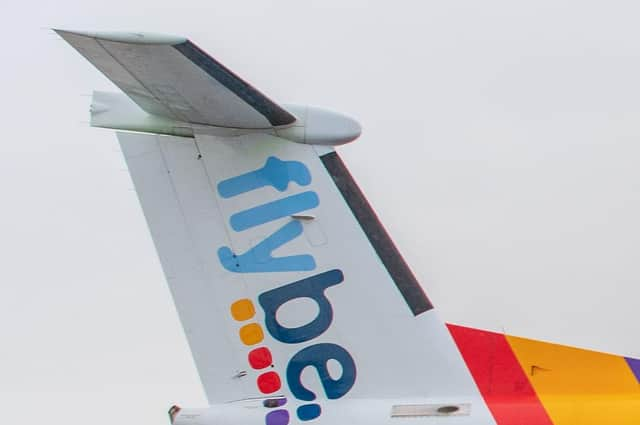 A Flybe craftcrshed after having the wheel wedges removed.