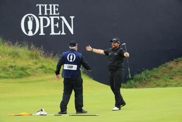Shane Lowry celebrates with his caddie Brian Bo Martin after his six-shot success at Royal Portrush. Picture: Andrew Redington/Getty Images.