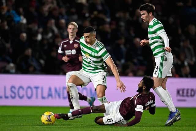 Celtic's Giorgos Giakoumakis is tackled by Hearts' Beni Baningime . (Photo by Rob Casey / SNS Group)