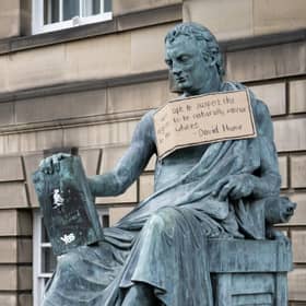 A poster hangs from the statue of the 18th Century philosopher David Hume on Edinburgh's Royal Mile, following a Black Lives Matter protest rally in June (Picture: Jane Barlow/PA)