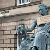 A poster hangs from the statue of the 18th Century philosopher David Hume on Edinburgh's Royal Mile, following a Black Lives Matter protest rally in June (Picture: Jane Barlow/PA)