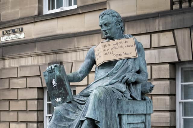 A poster hangs from the statue of the 18th Century philosopher David Hume on Edinburgh's Royal Mile, following a Black Lives Matter protest rally in June (Picture: Jane Barlow/PA)