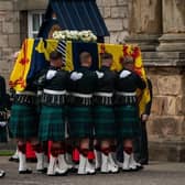 The Princess Royal curtseys the coffin of Queen Elizabeth II, draped with the Royal Standard of Scotland, as it arrives at Holyroodhouse, Edinburgh, where it will lie in rest for a day.