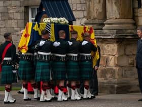 The Princess Royal curtseys the coffin of Queen Elizabeth II, draped with the Royal Standard of Scotland, as it arrives at Holyroodhouse, Edinburgh, where it will lie in rest for a day.