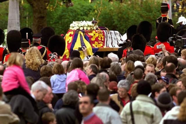 Mourners watch the gun carriage carrying coffin of Queen Elizabeth, the Queen Mother en-route to Westminster Abbey after leaving Westminster Hall where she has been lying in state.   * .... The funeral is the culmination of more than a week of mourning for the royal matriarch, who died at the age of 101.   