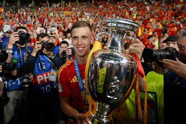 Dani Olmo poses with the trophy.