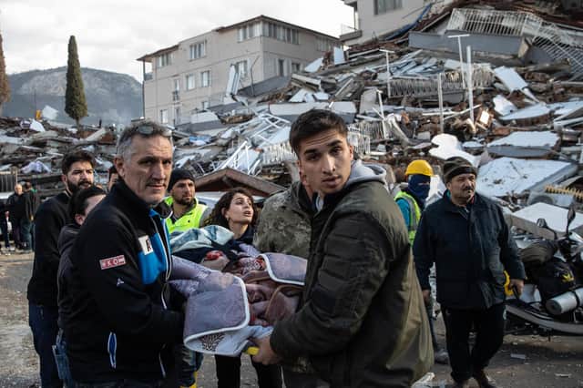 Rescue workers carry an earthquake survivor amid the ruins of collapsed buildings in Hatay, Turkey (Picture: Burak Kara/Getty Images)