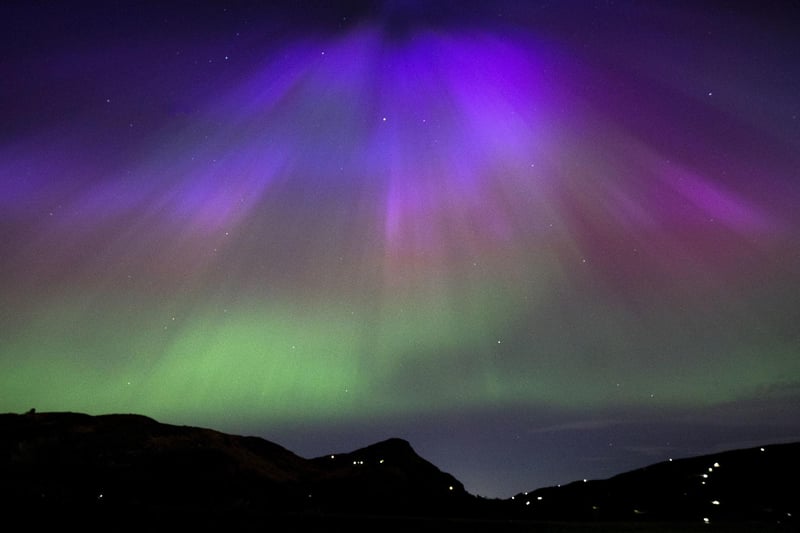 The aurora borealis, also known as the northern lights, above Arthur’s Seat and Salisbury Crags in Holyrood Park, Edinburgh