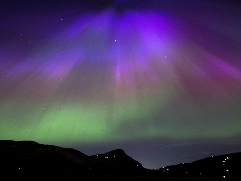 The aurora borealis, also known as the northern lights, above Arthur’s Seat and Salisbury Crags in Holyrood Park, Edinburgh