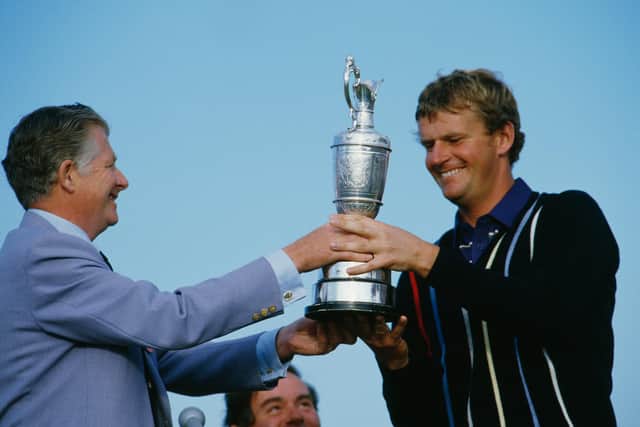 Sandy Lyle receives the Claret Jug at Royal St George's after his 1985 Open triumph.