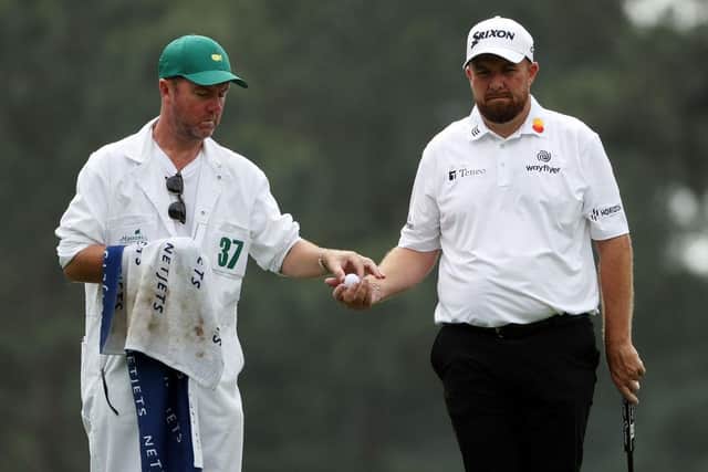 Shane Lowry talks with his caddie Darren Reynolds on the third green. Picture: Patrick Smith/Getty Images.