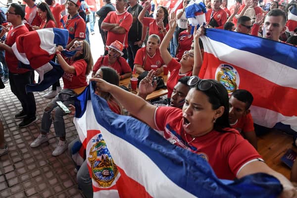 Costa Rican football fans react after watching their team qualify for the World Cup.
