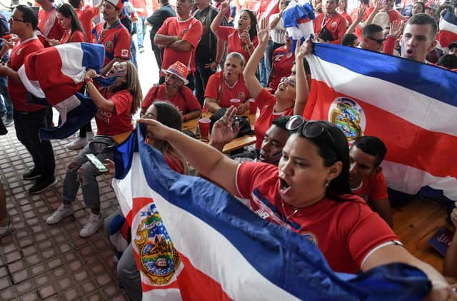 Costa Rican football fans react after watching their team qualify for the World Cup.