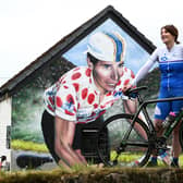Philippa York, who previously competed as Robert Millar, beside the mural in Lennoxtown which celebrates the cyclist's achievements at the first Briton to be crowned 'King of the Mountains' in the Tour de France. Picture: John Devlin