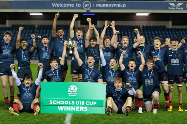 Merchiston's players celebrate with the trophy after the under-18s cup final