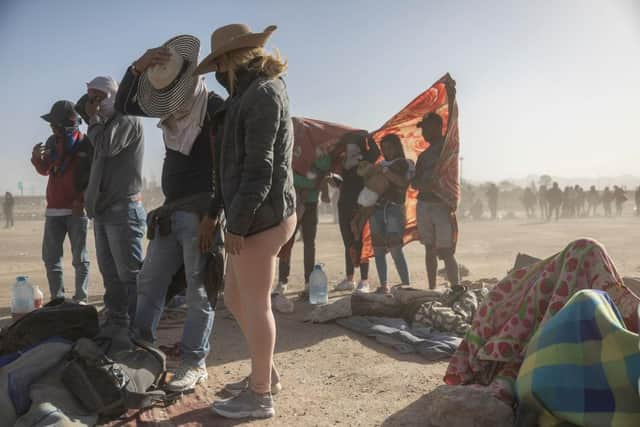 Immigrants from Venezuela cover up during a dust storm at a makeshift immigrant camp located between the Rio Grande and the U.S.-Mexico border fence in El Paso, Texas. The number of immigrants reaching the border has surged with the end of the US government's Covid-era Title 42 policy, which for the past three years has allowed for the quick expulsion of irregular migrants entering the country. Picture: Getty Images