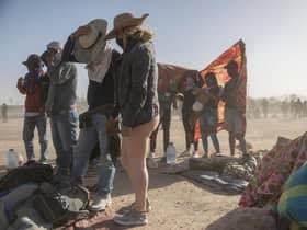 Immigrants from Venezuela cover up during a dust storm at a makeshift immigrant camp located between the Rio Grande and the U.S.-Mexico border fence in El Paso, Texas. The number of immigrants reaching the border has surged with the end of the US government's Covid-era Title 42 policy, which for the past three years has allowed for the quick expulsion of irregular migrants entering the country. Picture: Getty Images
