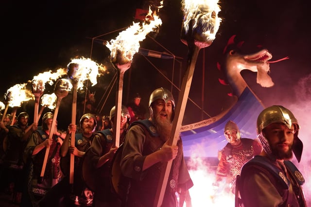 Squad members take part in the torch procession in Lerwick on the Shetland Isles during the Up Helly Aa fire festival. Originating in the 1880s, the festival celebrates Shetland's Norse heritage.  Picture: Andrew Milligan/PA Wire