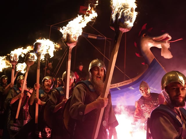 Squad members take part in the torch procession in Lerwick on the Shetland Isles during the Up Helly Aa fire festival. Originating in the 1880s, the festival celebrates Shetland's Norse heritage.  Picture: Andrew Milligan/PA Wire
