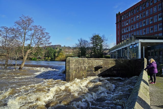 Visitors to Belper Mills have a nervous peek at the fast-flowing Derwent.