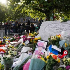 A photo of Queen Elizabeth II left among the flowers laid by members of the public at Balmoral  (Pic: PA/Andrew Milligan)