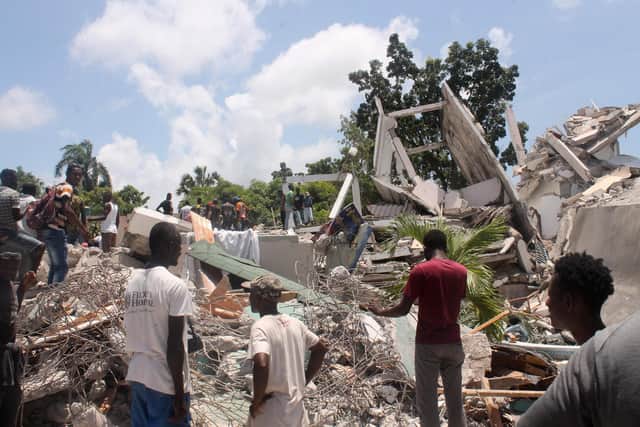 People search through the rubble of what used to be the Manguier Hotel after the earthquake hit. Picture: Stanley Louis/AFP via Getty Images