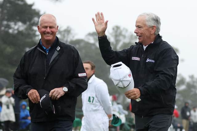 Sandy Lyle and Larry Mize acknowledge patrons on the 18th green after the former winners both brought the curtain down on their careers in the 87th Masters. Picture: Christian Petersen/Getty Images.