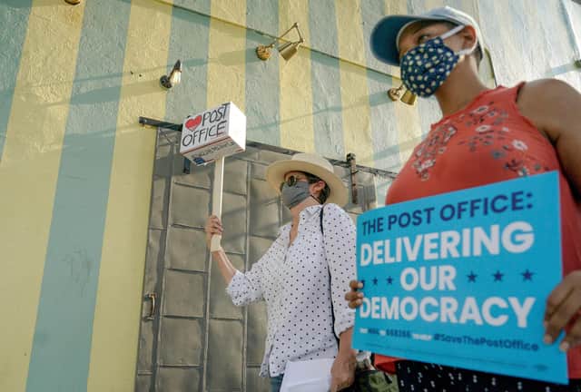 Protesters march in Los Angeles during a "Save the Post Office" demonstration (Picture: Kyle Grillot/AFP via Getty Images)