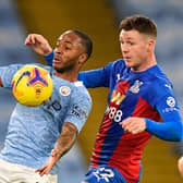 James McCarthy keeps a close eye on Manchester City forward Raheem Sterling