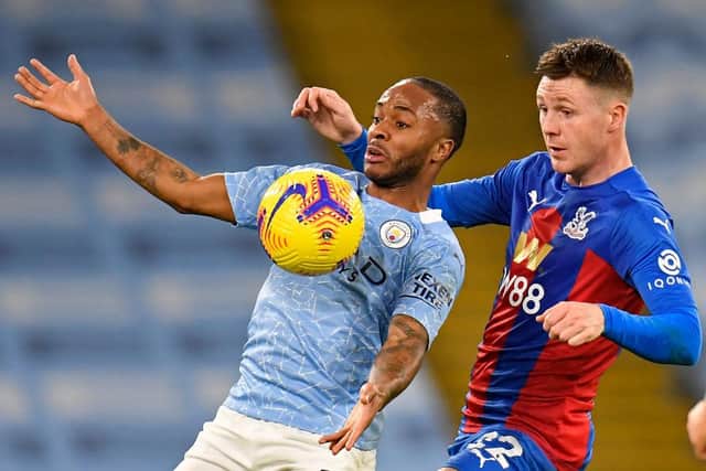 James McCarthy keeps a close eye on Manchester City forward Raheem Sterling