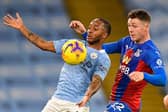 James McCarthy keeps a close eye on Manchester City forward Raheem Sterling