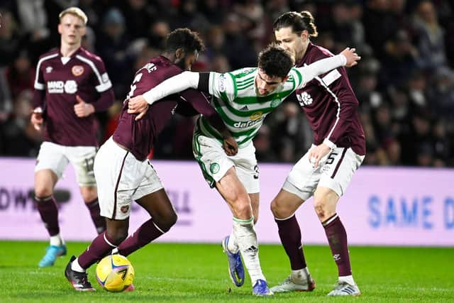 Celtic's Matt O'Riley (right) holds off Hearts' Beni Baningime.