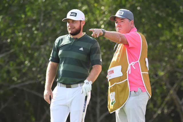 Tyrrell Hatton and caddie Mick Donaghy talk tactics during the final round of the Abu Dhabi HSBC Championship. Picture: Ross Kinnaird/Getty Images.