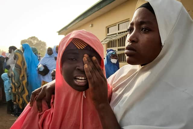 A girl is reunited with a family member in Jangebe, Zamfara state, on Wednesday after she and others they were kidnapped from a boarding school in northwestern Nigeria on February 26 (Picture: Aminu Abubakar/AFP via Getty Images)