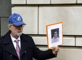 Paul Hudson holds a picture of his daughter Melina, a victim of the Lockerbie bombing, outside a court in Washington DC where alleged bombmaker Abu Mas’ud made a brief appearance this month (Picture: Anna Moneymaker/Getty Images)