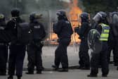 Derbyshire police said they are ‘monitoring the information about any events planned’ while a ‘full operational and resourcing plan’ is in place. Pictured are riot police officers outside the Holiday Inn Express Hotel which is housing asylum seekers in Rotherham.