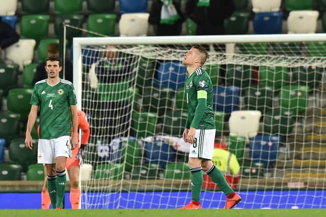 Tom Flanagan of Northern Ireland and Steven Davis react after Slovakia score their second goal during the UEFA EURO 2020 Play-Off Final (Photo by Charles McQuillan/Getty Images)