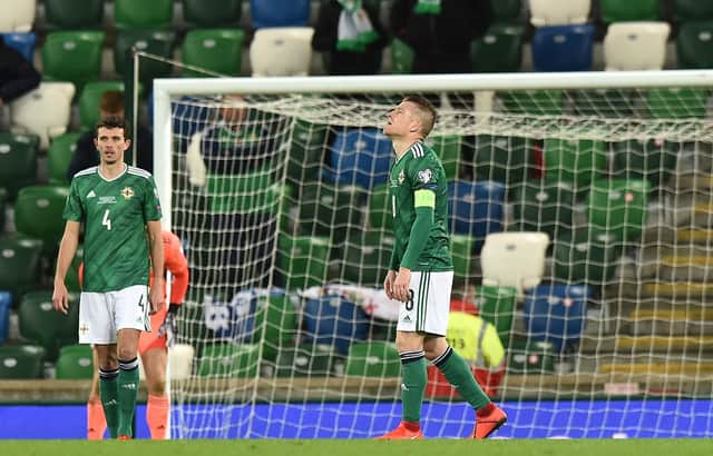 Tom Flanagan of Northern Ireland and Steven Davis react after Slovakia score their second goal during the UEFA EURO 2020 Play-Off Final (Photo by Charles McQuillan/Getty Images)