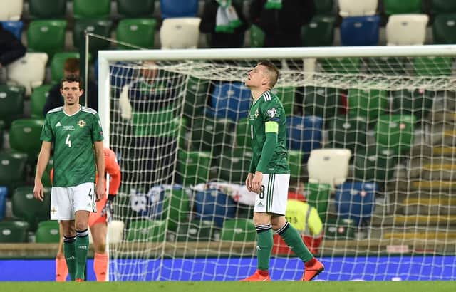 Tom Flanagan of Northern Ireland and Steven Davis react after Slovakia score their second goal during the UEFA EURO 2020 Play-Off Final  (Photo by Charles McQuillan/Getty Images)