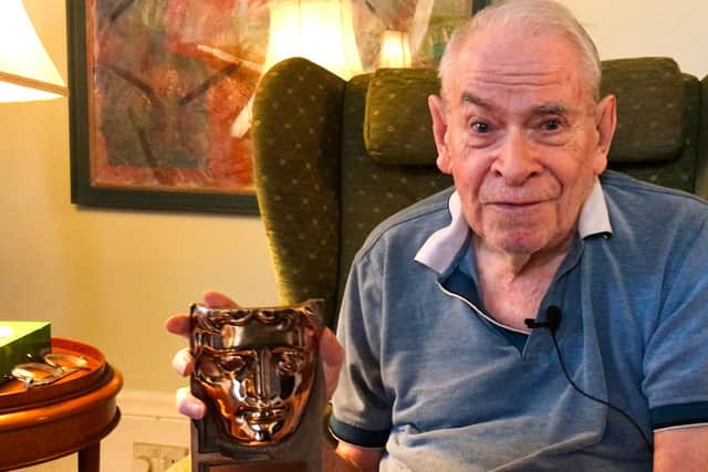Stanley Baxter receiving his Bafta Scotland Award at his home in London.