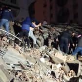 Rescuers search for victims of a 7.8-magnitude earthquake that hit Diyarbakir, in southeastern Turkey, levelling buildings across several cities and causing damages in neighbouring Syria. (Photo by Mahmut BOZARSLAN / AFPTV / AFP) (Photo by MAHMUT BOZARSLAN/AFPTV/AFP via Getty Images)